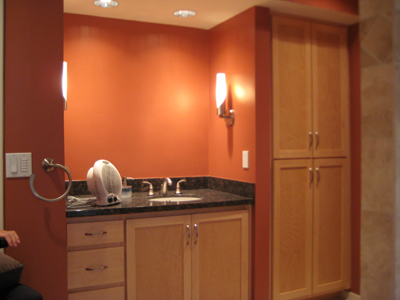 after: one sink replaces the two, allowing for a floor to ceiling cabinet at right